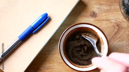 A cup of coffee and a notebook with a pen. The concept of freelancing photo