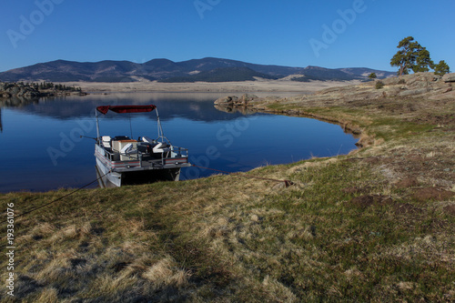 Pontoon Boat at the edge of Eleven Mile Reservoir  Colorado USA.