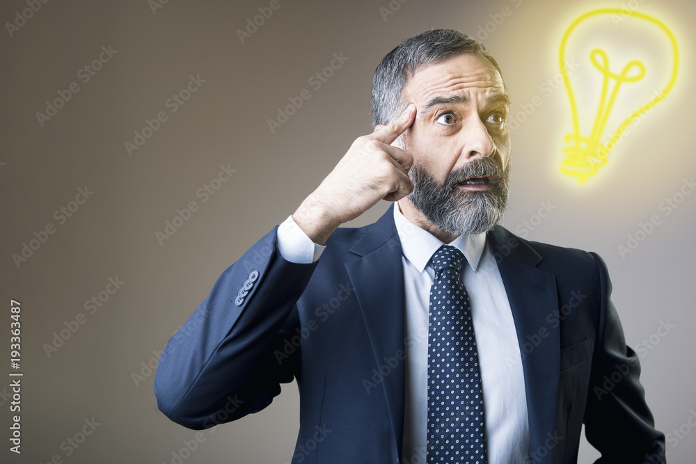 Senior business man thinking of a genius idea for his successful project Senior business man thinking of a genius idea for his successful project