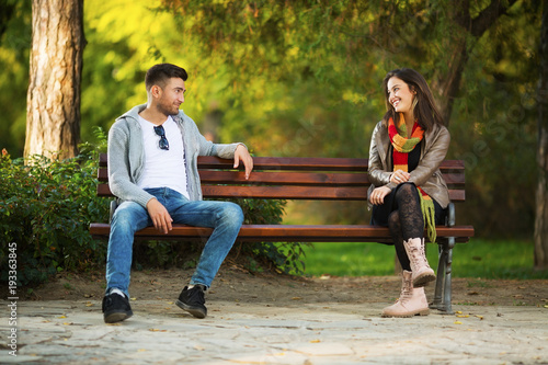Young couple in park flirting photo