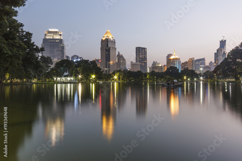 Business district cityscape from a park with twilight time from lumpini park  Bangkok Thailand