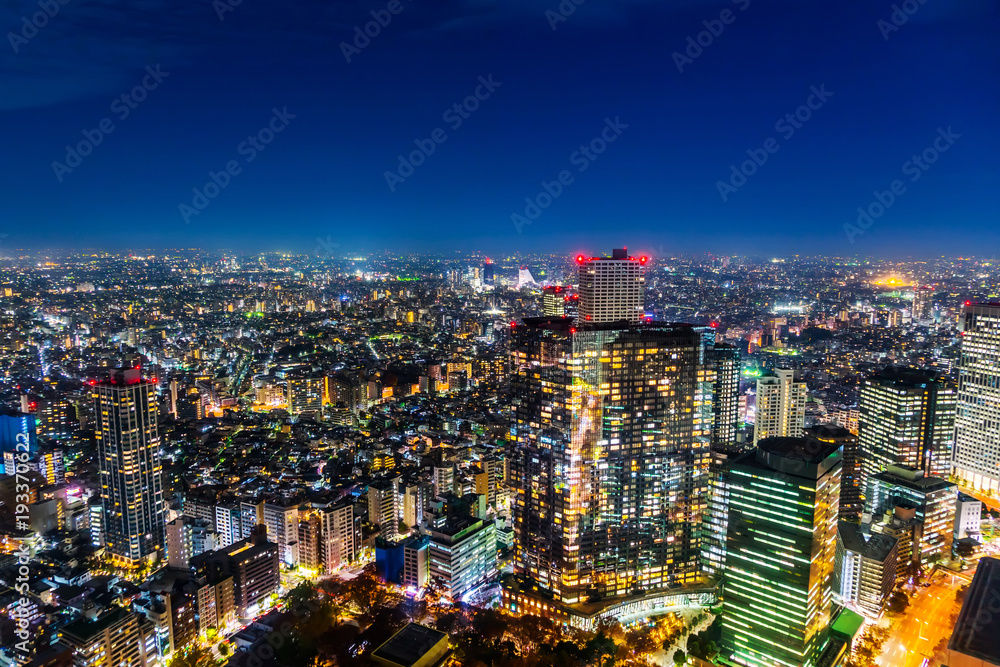 Naklejka premium Asia Business concept for real estate and corporate construction - panoramic modern city skyline aerial night view of Shinjuku area under twilight sky in Tokyo, Japan