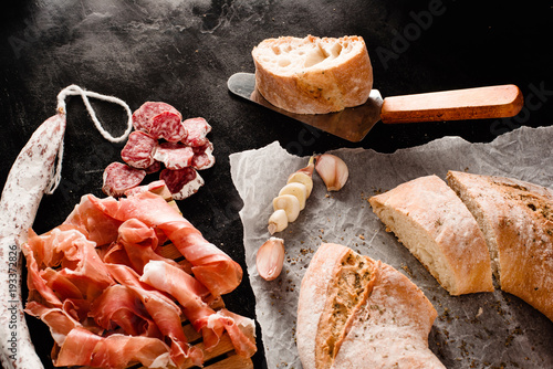 Traditional Galician cut white bread with moldy salami and jamon photo