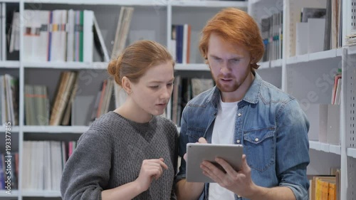 Young Teammates Reacting to Loss Email on Tablet PC, Upset photo