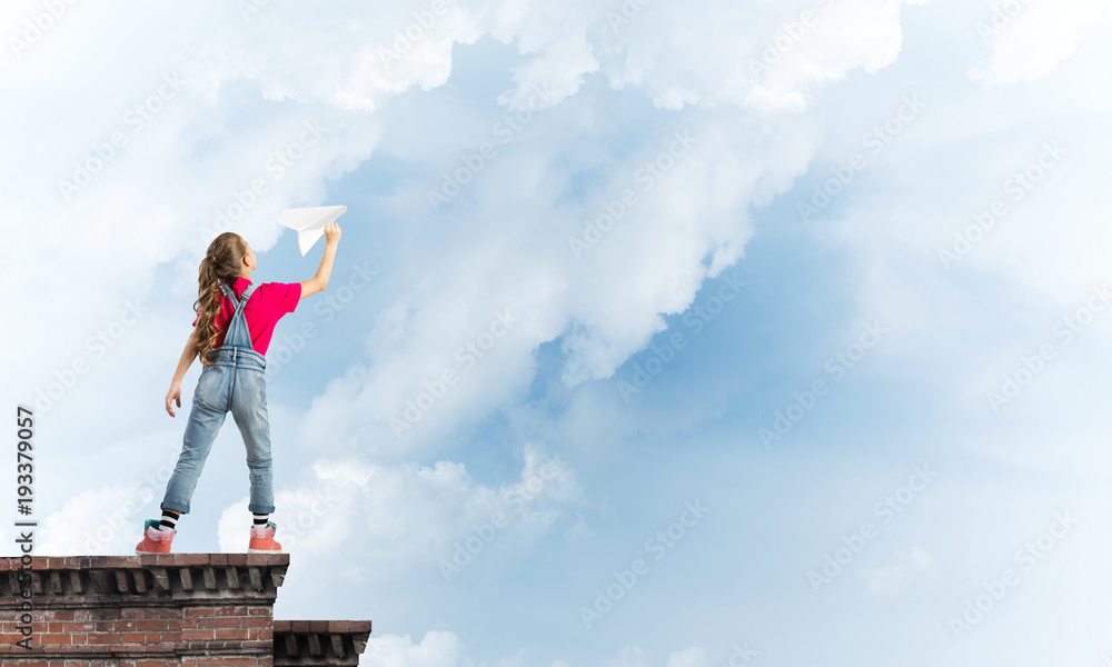 Concept of careless happy childhood with girl dreaming to become pilot Concept of careless happy childhood with girl dreaming to become pilot