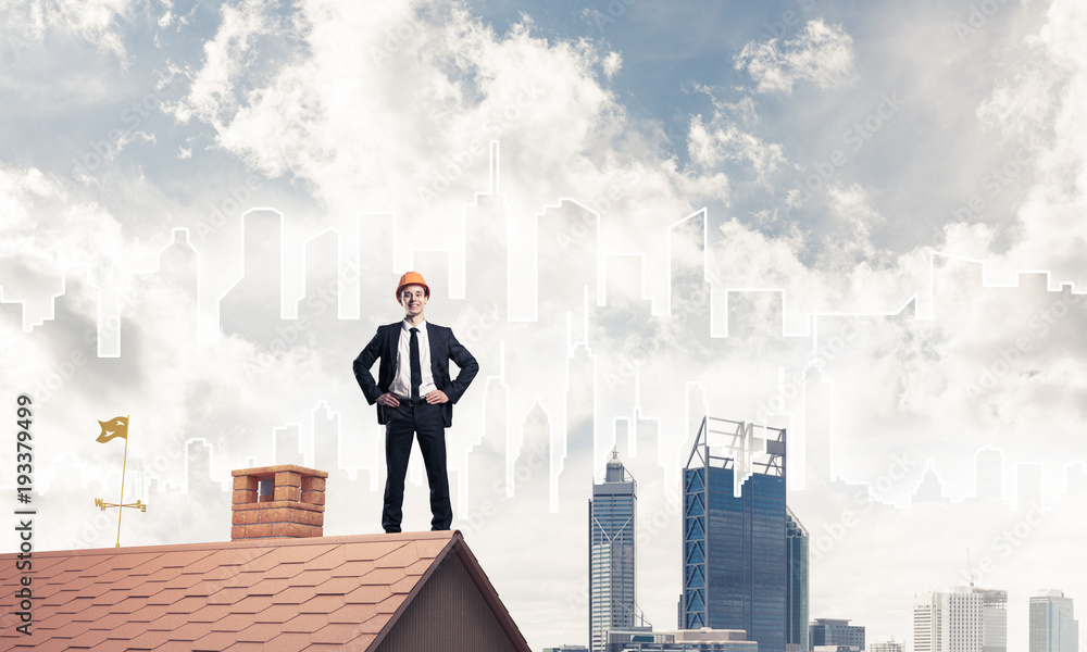 Engineer man standing on roof and looking away. Mixed media Engineer man standing on roof and looking away. Mixed media
