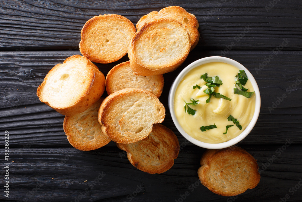 Easy appetizer crostini and cheese sauce close-up. horizontal top view Easy appetizer crostini and cheese sauce close-up. horizontal top view
