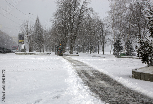 Snow cleaning buses in town during heavy snowfall