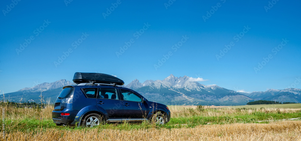 car for traveling with a roof rack on a mountain road