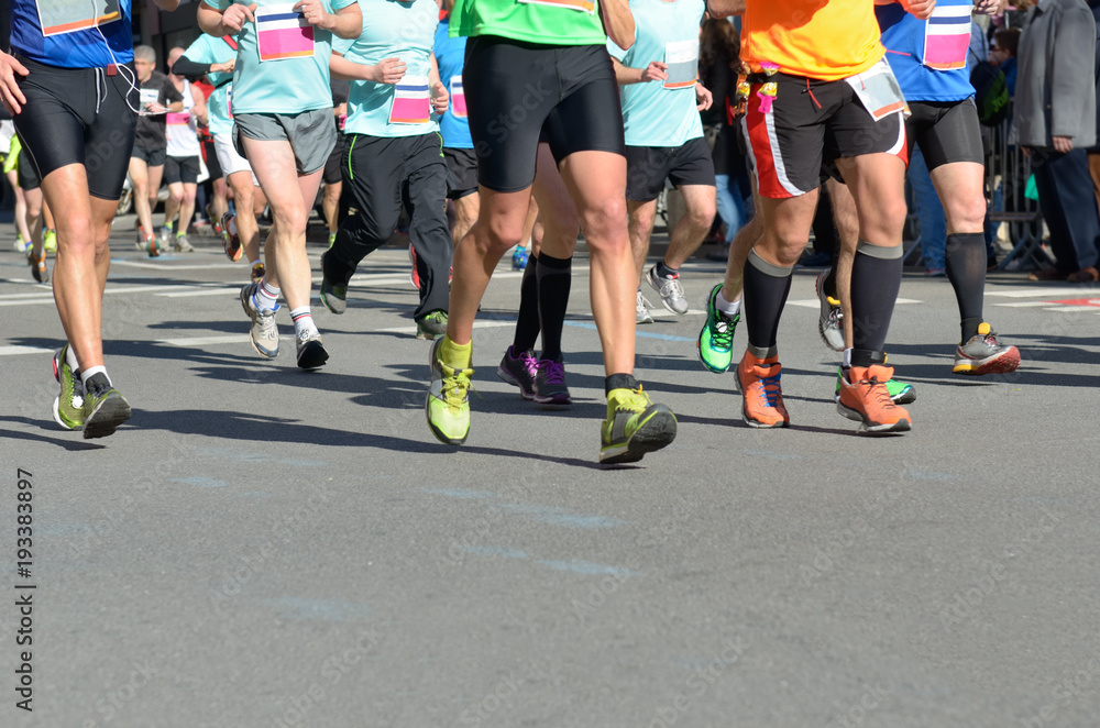 Marathon running race, many runners feet on road racing, sport competition, fitness and healthy lifestyle concept
Marathon running race, many runners feet on road racing, sport competition, fitness and healthy lifestyle concept