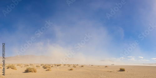 Strong winds blow a massive sandstorm across the open desert of the southwest.