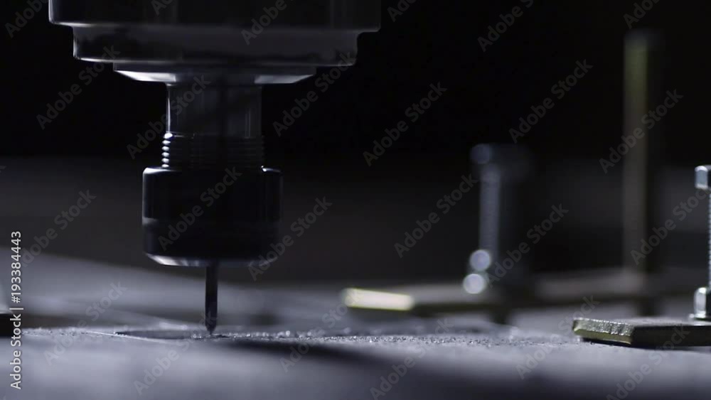 In a beautiful light, the drill bit slowly carves out the aluminum plate company name for advertising brand and logo. In a beautiful light, the drill bit slowly carves out the aluminum plate company name for advertising brand and logo.