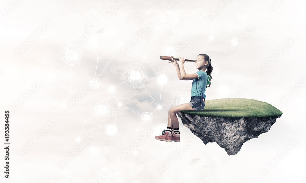 Concept of careless happy childhood with girl looking in spyglas Concept of careless happy childhood with girl looking in spyglas