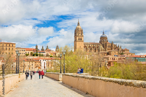 SALAMANCA, SPAIN, APRIL - 17, 2016: The Cathedral and bridge Puente Romano over the Rio Tormes river.