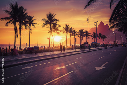 Sunset on Ipanema Beach with Dois Irmaos mountains in Rio de Janeiro, Brazil. Violet tone