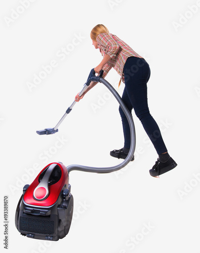 Rear view of a woman with  vacuum cleaner