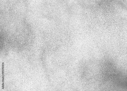 Subtle grain texture. Abstract black and white gritty grunge background. Dark paint spray particles on paper photo