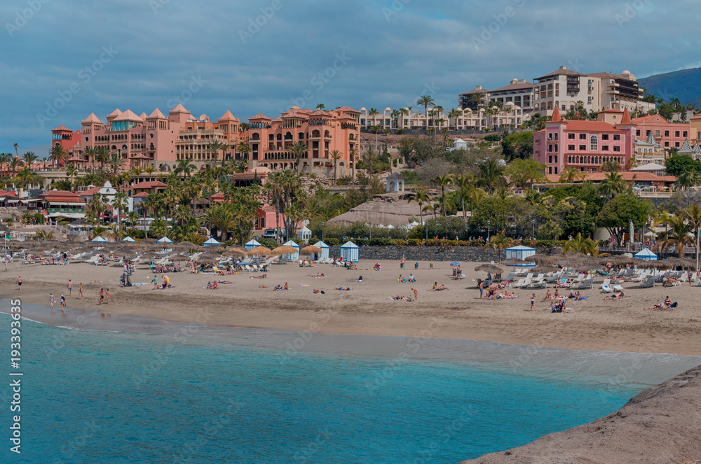 Beautiful coastal view of  El Duque beach with with warm turquoise water and gold sand in Costa Adeje, Tenerife, Canary islands, Spain.
