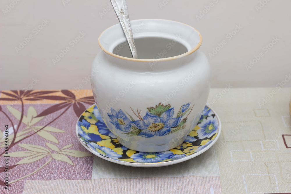 Colorful ceramic mugs with enamel look on blue wooden