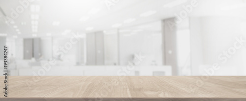 Empty wood table top and blurred bokeh office interior space banner background - can used for display or montage your products.