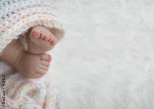 baby feet in blanket, copy space. selected focus © arizanko