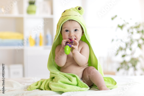 Baby boy with green towel a...