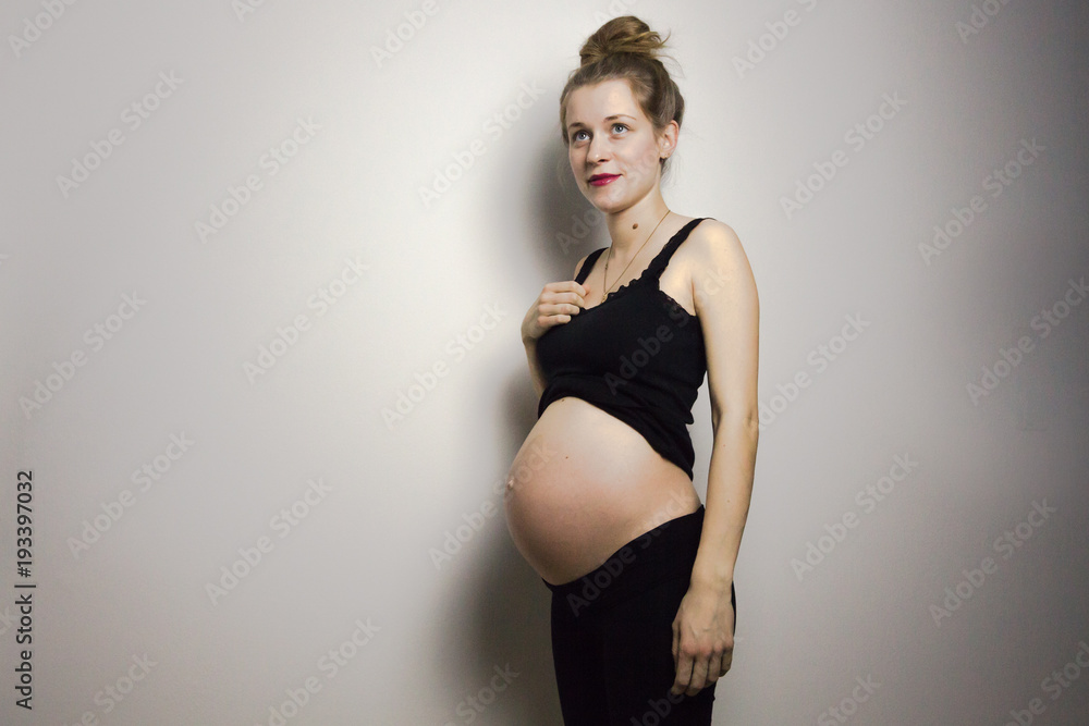 beautiful pregnant young woman posing in lingerie and showing her belly beautiful pregnant young woman posing in lingerie and showing her belly
