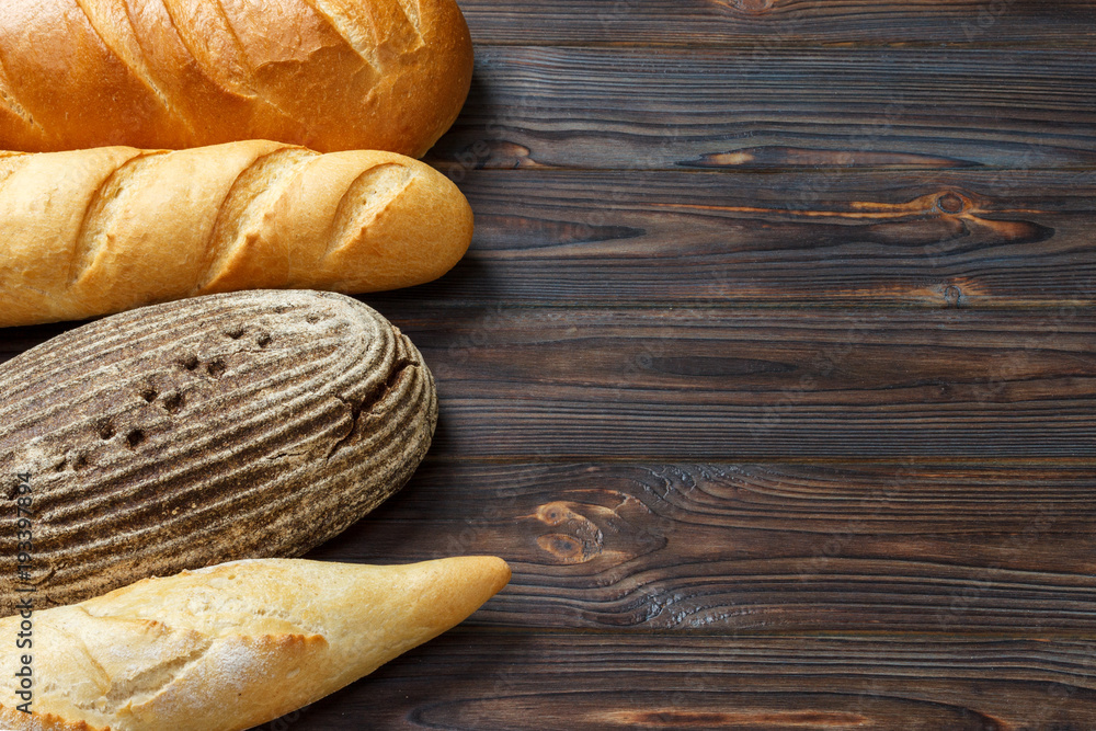Bakery background, bread assortment on black wooden backdrop. Top view with copy space Bakery background, bread assortment on black wooden backdrop. Top view with copy space