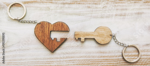 The beautiful trinket in shape of heart is made like a puzzle on the wooden desk
