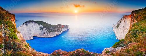 Greece. Epic sunset scenery of Zate island, full name is Zakynthos - popular summer resort and European travel destination in Greece. Picturesque Navagio beach panorama with shipwreck landmark. photo