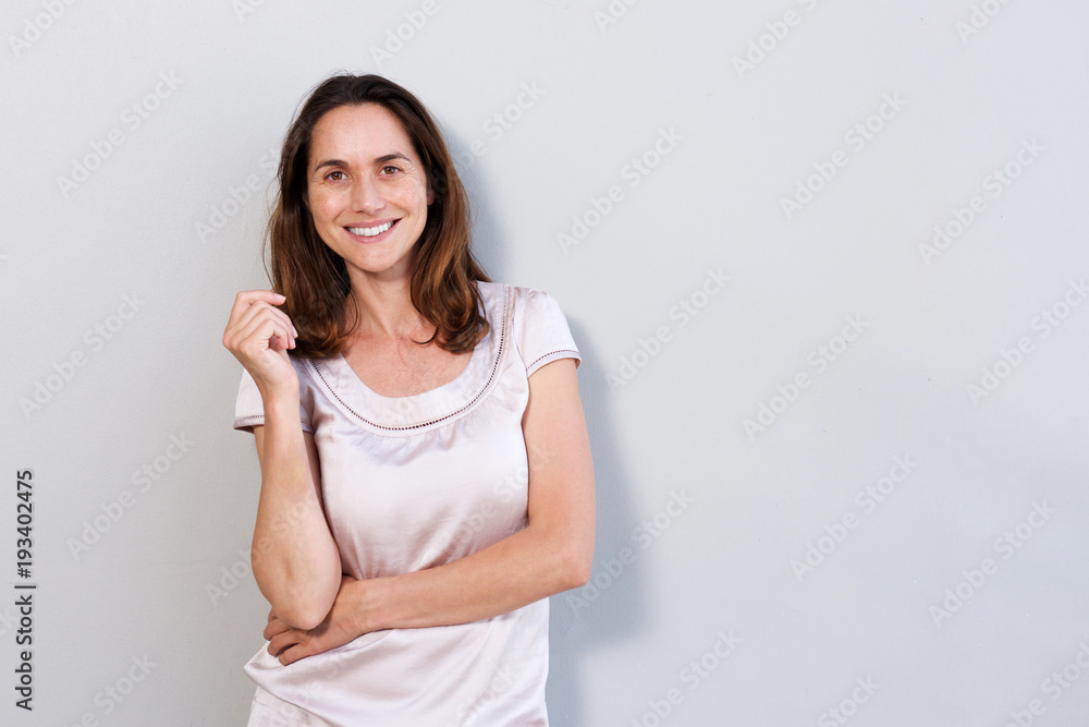 happy older woman standing against white background happy older woman standing against white background
