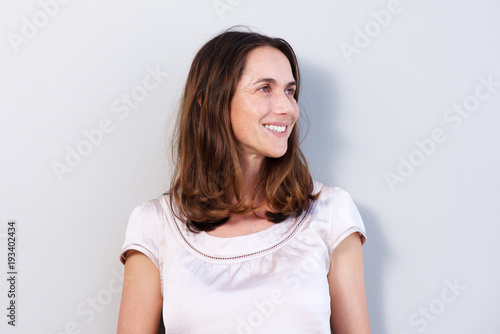 older woman smiling against white background