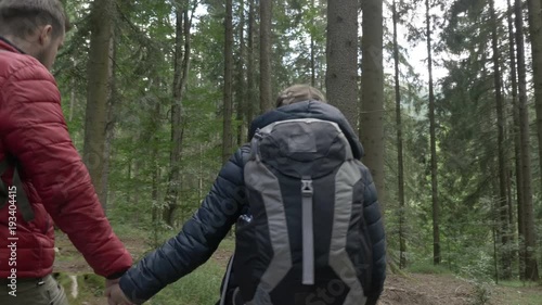 Wallpaper Mural Young loving environmentalist couple hiking hand in hand on a mountain trail exploring nature Torontodigital.ca