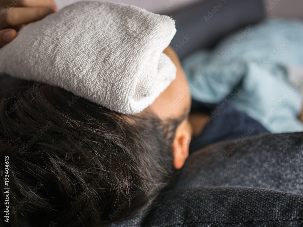 Towel on forehead, on man feels sick Towel on forehead, on man feels sick