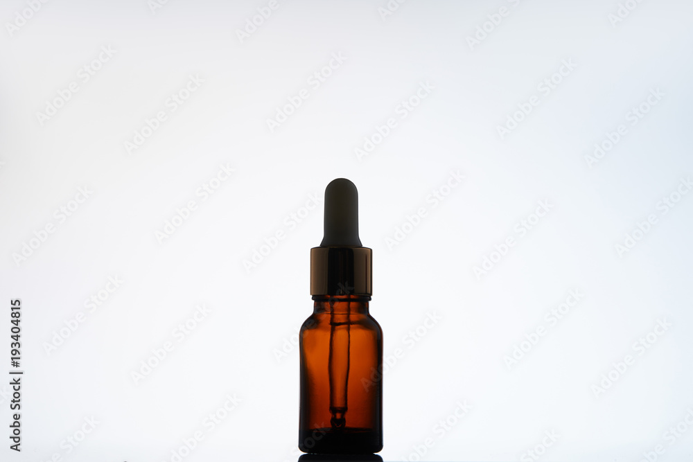 Obraz premium bottle of aromatic oil with pipette on white