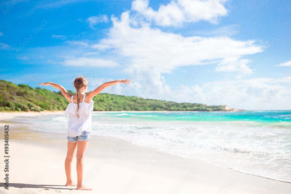 Adorable little girl on wild exotic beach at tropical caribbean island Adorable little girl on wild exotic beach at tropical caribbean island