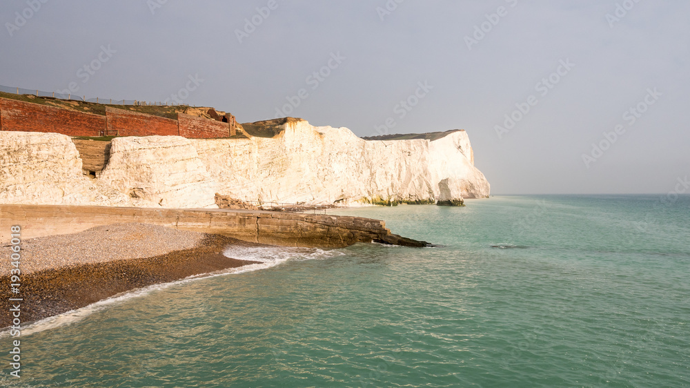 Seaford chalk cliffs, East Sussex, England. The white cliffs of the South Downs on England's southern coast on a calm dusky evening. Seaford chalk cliffs, East Sussex, England. The white cliffs of the South Downs on England's southern coast on a calm dusky evening.