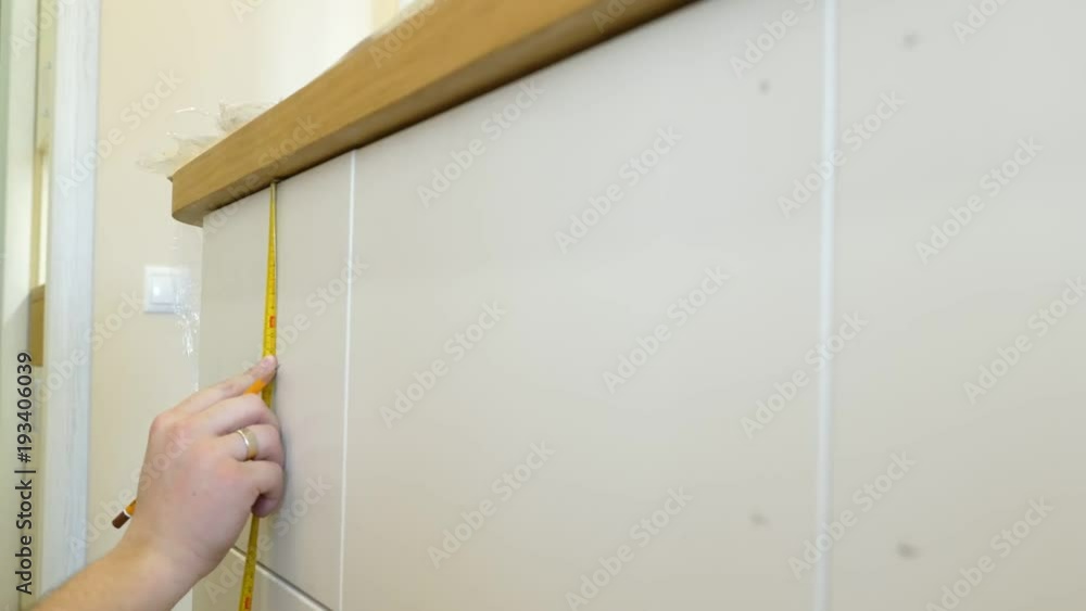 Man is preparing to install handles on new furniture. Man is preparing to install handles on new furniture.