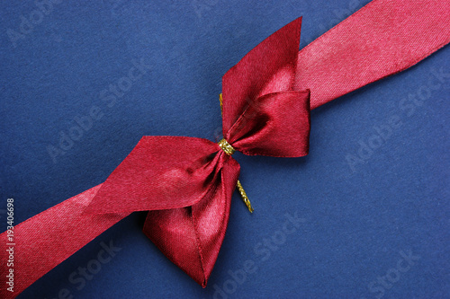 Blue Christmas gift box with red bow and ribbon