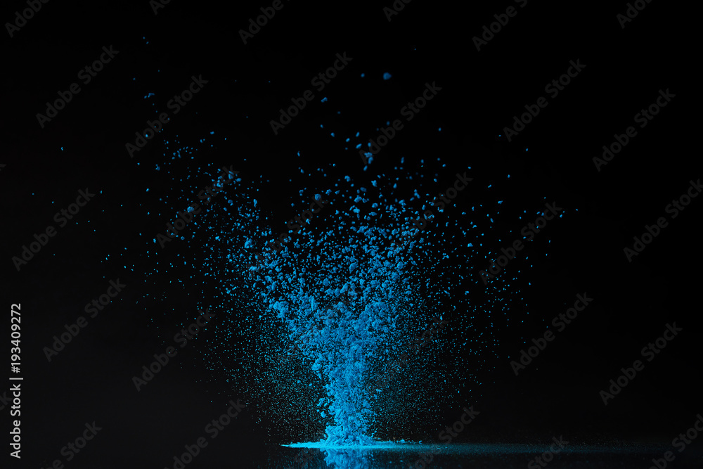 Obraz premium blue holi powder explosion on black