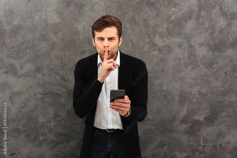 Businessman showing silence gesture chatting Businessman showing silence gesture chatting