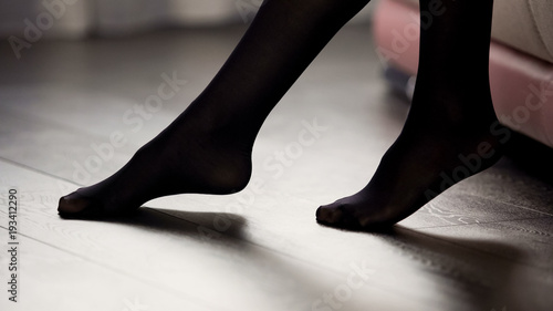 Elegant female legs in black tights on the floor, style and fashion, clothing photo