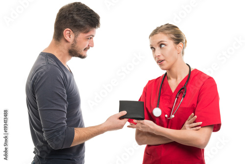 Male patient giving wallet to female doctor.
