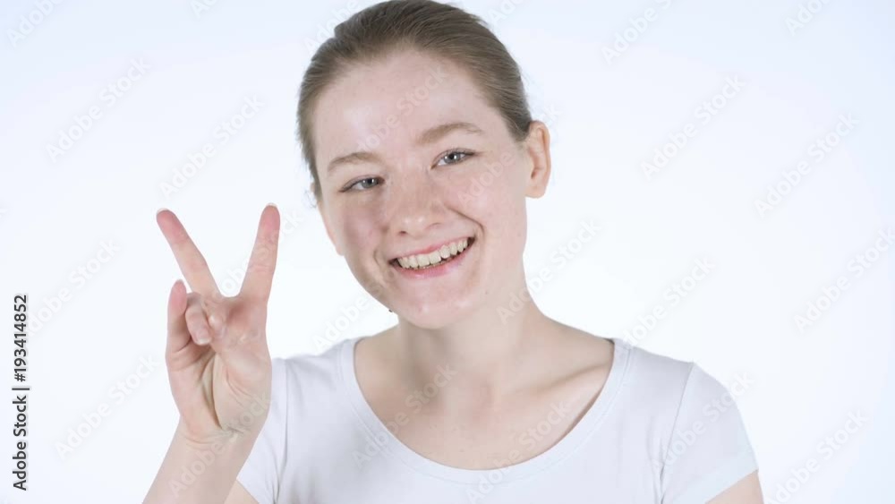 Victory Sign by Young Redhead Woman Victory Sign by Young Redhead Woman