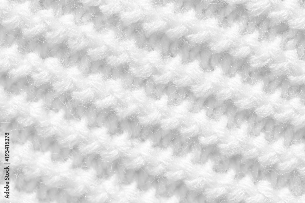 Knitting from woolen threads handmade. The texture is white, the background of the canvas is connected from the thread. Knitting from woolen threads handmade. The texture is white, the background of the canvas is connected from the thread.