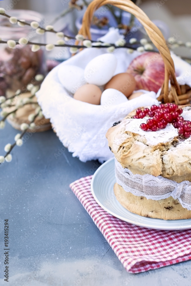 Sweet easter bread with berries, on the table by the window. Branches of a spring tree. The city is outside the window. Red napkin. Free space for text or a postcard. Sweet easter bread with berries, on the table by the window. Branches of a spring tree. The city is outside the window. Red napkin. Free space for text or a postcard.