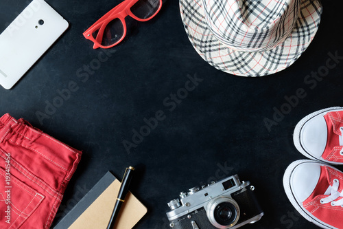 vintage fineart film photography set of red sneakers, red glasses, red jeans, vintage camera, white phone, notebook, stylus pen, checkered hat