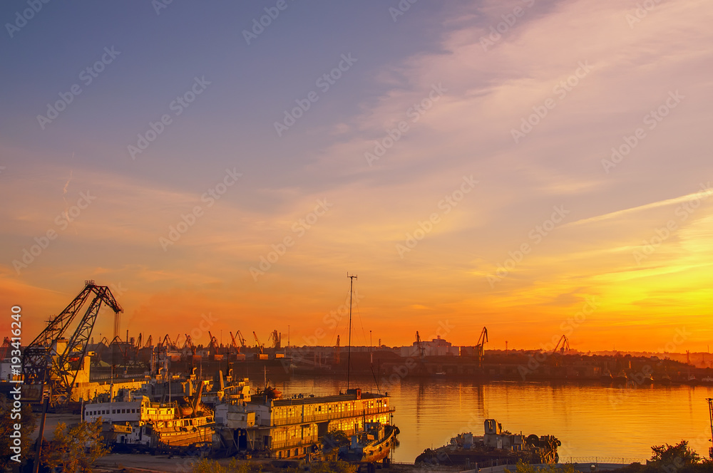 View of the port at sunset. Silhouettes of the cranes in the sunset.
View of the port at sunset. Silhouettes of the cranes in the sunset.