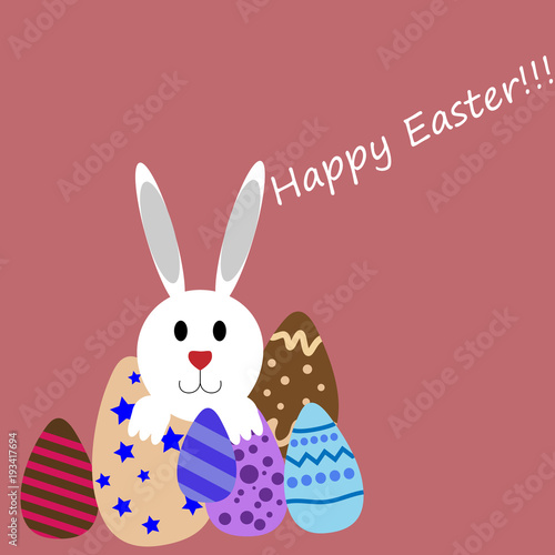 Rabbit hiding behind easter eggs.