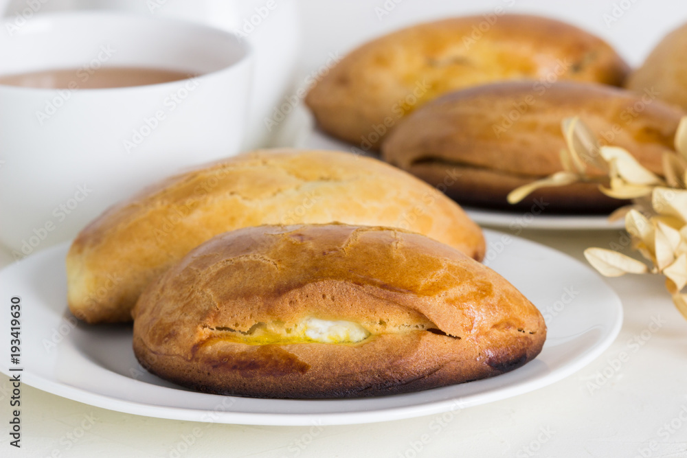 Homemade pies  with cottage cheese and  tea.